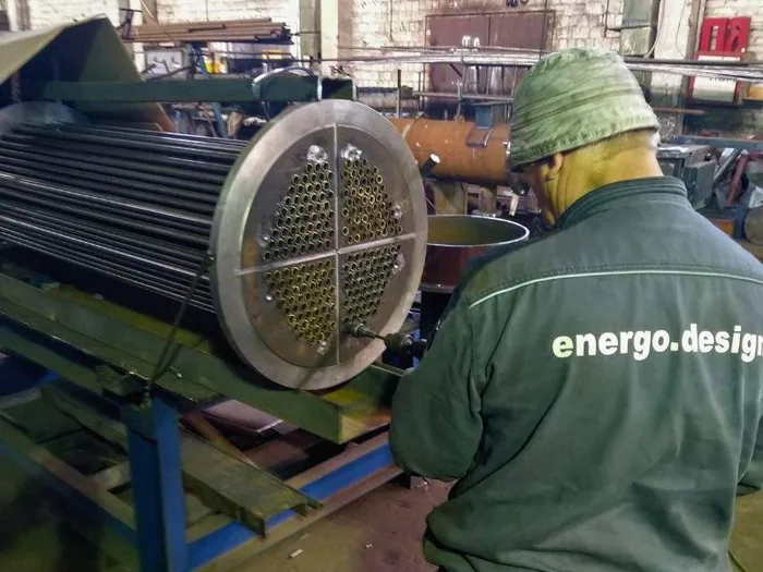 Робочий закріпляє труби в трубній дошці методом вальцювання